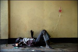A severely wounded man lies unattended in a Bangui mosque, Bangui, Central African Republic, today following a day-long gun battle between Seleka soldiers and Christian militias.