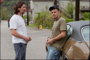 Christian Bale, left, and Casey Affleck  in a scene from 
