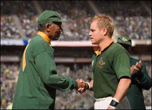 In this image released by Warner Bros.,Morgan Freeman portrays Nelson Mandela, left, and Matt Damon portrays Francois Pienaar in a scene from the film, 