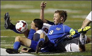 Anthony Wayne's JJ Fortner (9) collides with  Mentor's Brock Venman (9) during a Division I boys state soccer semifinal Wednesday, Nov. 6, 2013, at Perkins High School in Sandusky, Ohio. Mentor defeated Anthony Wayne 1-0.