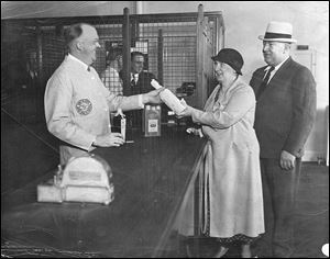 Mr. and Mrs. George Lumley attend a liquor store opening on Huron Street. Liquor stores had to be state-owned until the 1990s. 