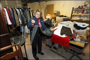Volunteer Mary Pat Perry organizes the clothing donations Wednesday while working in the ReTail Shop, a new thrift store to help fund organization operations for the Toledo Area Humane Society.