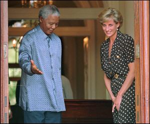 In March, 1997, then South African President Nelson Mandela, left, shows the way to Britain's Princess Diana in Cape Town, South Africa, where they discussed the threat of AIDS in the country.