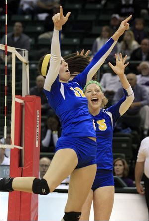 St. Ursula's Lauren Daudelin, 12, and Elizabeth Coil, 15, celebrate another point  during a Div. I state semi-final volleyball game on Nov. 7, 2013 at the Nutter Center in Fairborn, Ohio.