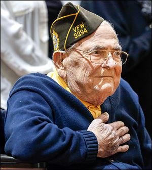 World War II veteran Charles Malachosky, 92, of Cuyahoga Falls, Ohio, dons his Veterans of Foreign Wars hat and remains at attention. 