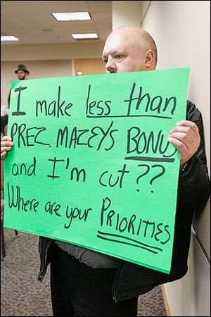 David Sennerud, a journalism instructor set to lose his job at BGSU for a third time because of staffing cuts, shows his feelings. President Mary Ellen Mazey said that con-tractually,she couldnot refuseto accepther bonus. 