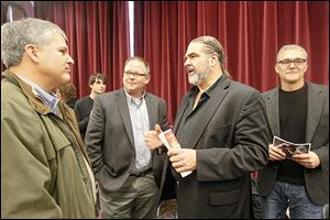 Ford P. Weber, chief executive of the Lucas County Economic Development Corp., left, Guy Stout, Brett Leonard, and Steve Guinan meet at the Toledo School for the Arts to discuss Mr. Leonard’s planned film, ‘Perfect Season.’ Students were given a short preview of the film about the Toledo Troopers.