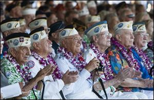 Pearl Harbor survivors watch a vintage World War II airplane fly over Pearl Harbor at the ceremony commemorating the 72nd anniversary of the attack on Pearl Harbor today in Honolulu.
