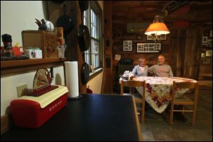 Nancy Angerman, left, and her husband, Tom Hutter, sit in the kitchen area of the home.
