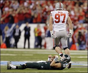 Ohio State's Joey Bosa (97) reacts after sacking Michigan State's Connor Cook during the first half in Indianapolis. 