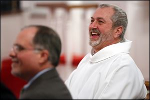 Rector Jeffry Bunke laughs during a light-hearted moment at his installation at St. Timothy’s Episcopal Church in Perrysburg. Rev. Bunke was installed on Thursday. He arrived at the parish in October.