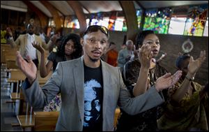 Mourners attend an early morning church service in memory of Nelson Mandela at the Regina Mundi church, which became one of the focal points of the anti-apartheid struggle, in Soweto, Johannesburg, 