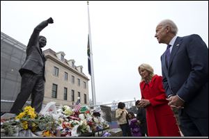 Vice President Joe Biden, right, and wife Jill Biden, pay their respects to former South African President Nelson Mandela outside the South African embassy in Washington, today, after signing a condolence book inside. 
