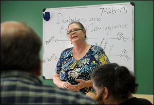 Katie Phillips leads a diabetes support class at the Wernert Center. Diabetes and mental illness are viewed as often deeply connected in adults. Research points to a link between treatment of mental illness and the reduction of physical disorders.