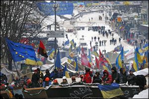 Pro-European Union activists get ready to defend their tent camp on the Independence Square in Kiev, Ukraine, today. The policemen, wearing helmets and holding shields, formed a chain across Kiev's main street outside the city building.