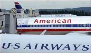 American Airlines emerged from bankruptcy protection and US Airways culminated its long pursuit of a merger partner when the two complete their deal Monday and created the world’s biggest airline.