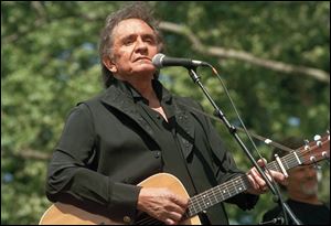 Johnny Cash performs at a benefit concert in Central Park in New York in May, 1993.
