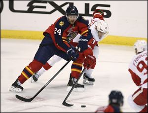 Florida Panthers' Brad Boyes (24) and Detroit Red Wings' Pavel Datsyuk (13) chase the puck during the second period.