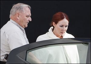 Shannon Richardson is escorted to a Titus County Sheriff's car after a court appearance in Texarkana, Texas in June.