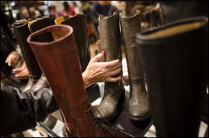 A customer places a boot back in the shoe section of the Macy's Herald Square flagship store, in New York. 