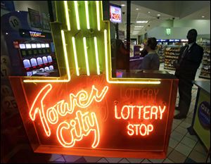 People line up to buy lottery tickets at the Tower City Lottery Shop Thursday in Cleveland.