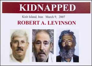 An FBI poster showing a composite image of retired FBI agent Robert Levinson, right, of how he would look like now after five years in captivity, and an image, center, taken from the video, released by his kidnappers, and a picture before he was kidnapped, left, displayed during a news conference in Washington, in March, 2012.
