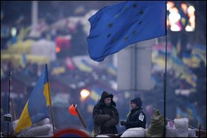 Pro-European Union activists stand atop of barricades during a rally in Independence Square in Kiev, Ukraine today.