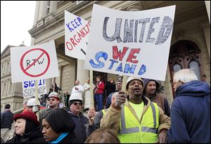 Union workers rally outside the Capitol in Lansing, Mich., in this 2012 file photo.