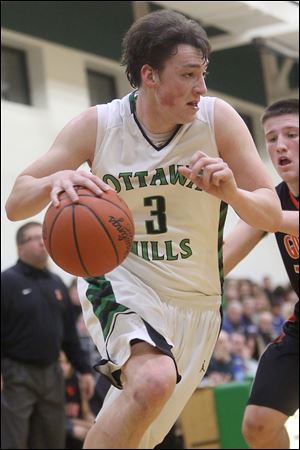 Ottawa Hills’ Geoff Beans (3) drives the baseline during the second quarter Friday night against Gibsonburg. The 6-foot-7 senior forward scored 13 points and added five rebounds as the Green Bears won at home.