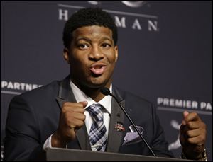 Florida State quarterback Jameis Winston talks to reporters after winning the Heisman Trophy, Saturday, Dec. 14, 2013, in New York.