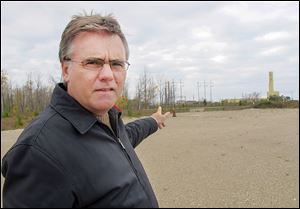 Neal Kelly, spokesman for Ontario Power Generation, stands in the area of the Bruce Power nuclear power complex in Kincardine, Ont., where the company proposes to drill a waste storage chamber.