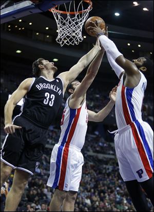 Brooklyn Nets forward Mirza Teletovic (33), Detroit Pistons forward Josh Harrellson (55) and center Andre Drummond (0) try to grab a rebound during the first half Friday in Auburn Hills, Mich.