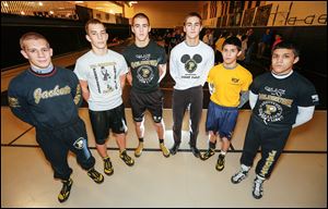 From left, J.P. and Chase Newton, Dan and Matt Waltermeyer, and Mario and Moises Guillen face off against each other during wrestling practice at Perrysburg High School, even though they are in different weight classes. Coach Sam Cotterman says he does it to ramp up the intensity of the practices. 