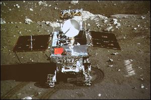 China’s first moon rover, ‘Jade Rabbit,’ is seen on the lunar surface in an area known as Sinus Iridum — the Bay of Rainbows.  