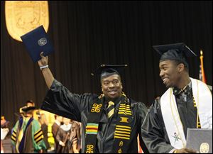 Eric Norvell II, left, and Taurean Young celebrate commencement at Savage Hall. Mr. Norvell of Elyria earned a bachelor of science in an individualized program, and Mr. Young of Dayton earned a bachelor of science in mechanical engineering.