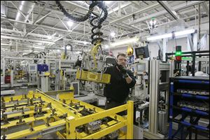 Jeff Roe works on a six-speed transmission. General Motors will invest in Toledo Transmission to upgrade its ability to make six-speed transmissions while preparing to make eight speeds.