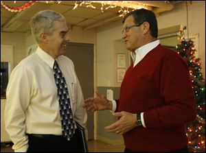 Ohio state Rep. Randy Gardner (6th District-R), left, congratulates retiring Rossford school board member Joseph Minarcin, Jr. for his 16 years of service on the board at the December meeting in Rossford, Ohio on December 21, 2009. 