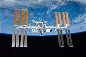 International Space Station is shown with the backdrop of Earth. 