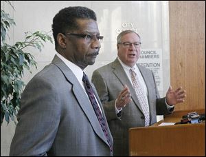TPD Lt. William Moton, left, is introduced as chief of police by mayor-elect D. Michael Collins.    