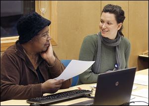 Veola Carpenter, left, seeks advice from Rachel Noleff, an outreach and enrollment worker for the Neighborhood Health Association, during a health-care forum at the Lagrange branch library.