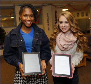 Eighth graders KnowEl Willhight, left, and Emily Rigby wrote 24,000-word and 10,000-word novels on their iPads respectively for the class and national project.