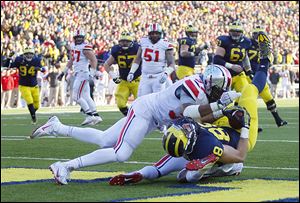 Michigan’s Jake Butt (88) lands in the end zone for a touchdown against Ohio State. The tight end has two scores this season.