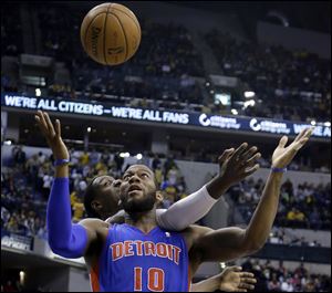 Indiana Pacers center Ian Mahinmi, back, comes from behind to knock the ball away from Detroit Pistons forward Greg Monroe in the first half Monday in Indianapolis.