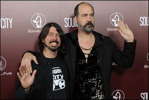 Dave Grohl, left, poses with Nirvana bandmate Krist Novoselic at the premiere of the documentary film 