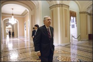 Senate Minority Leader Mitch McConnell, R-Ky., walks to the chamber for the final votes on the bipartisan budget deal.