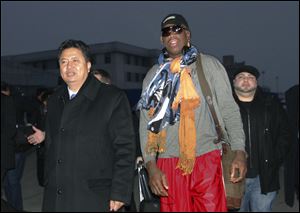 Former NBA basketball star Dennis Rodman walks with Vice Minister of North Korea's Sports Ministry, Son Kwang Ho, as Rodman arrives at the international airport in Pyongyang, North Korea today.