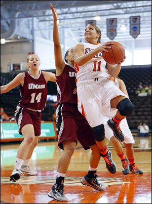 The Falcons’ Jillian Halfhill drives past Massachusetts’ Nola Henry during the first half Thursday at the Stroh Center. Halfhill scored seven points as BG rolled to a victory.