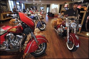 Sales specialist Jeff Eckman pushes an Indian Chieftain motorcycle through the showroom at the new Indian Motorcycles dealership, part of the Honda East Toledo dealership but in a separate building on Conant Street in Maumee. The first Indian arrived in the showroom on Nov. 1. 