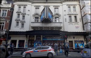 Police stand outside The Apollo Theatre in London, Friday. Authorities are carrying out a structural assessment at the Apollo Theatre after the partial collapse of its ceiling.