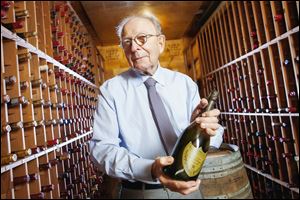 Dr. Ken Bleifer holds a 1990 Dom Perignon inside the wine cellar of his Los Angeles-area home, filled with nearly 1,800 bottles. When he began his collection he didn’t think of it as an investment.